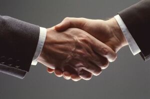 Two people shaking hands | Collection companies Michigan