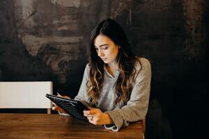 A woman on a tablet | Collection services Michigan