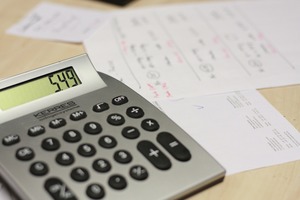 A calculator and paper | Collection services Michigan