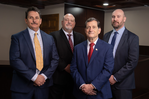 A photo of the four Muller attorneys, who specialize in commercial collections in Michigan.