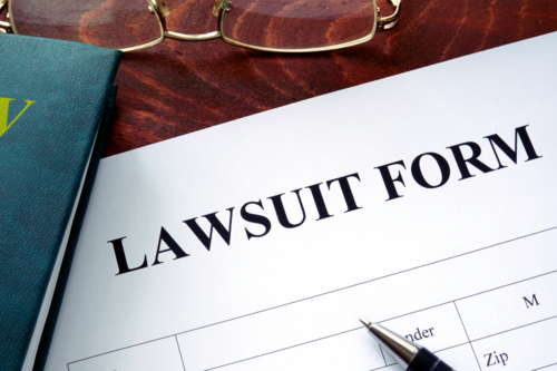Up-close photo of a lawsuit form on a lawyer's desk.